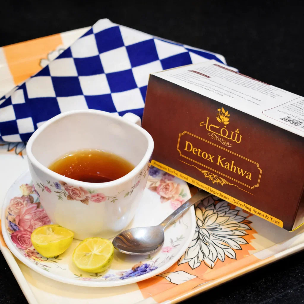 Theshiffaa Detox Kahwa herbal tea box with a floral cup, lemon slices, and spoon on tray