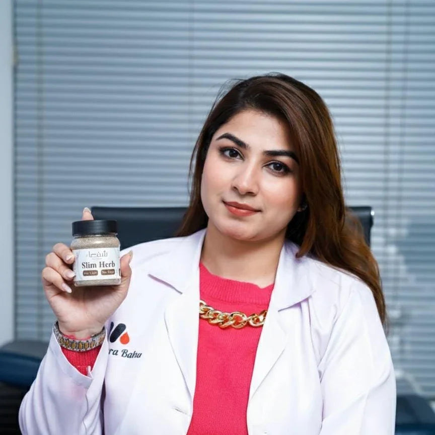 Woman in white coat holding Theshiffaa Slim Herb jar, office background with blinds.